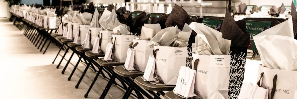 Rows of curated gift bags prepared for a VIP fashion event